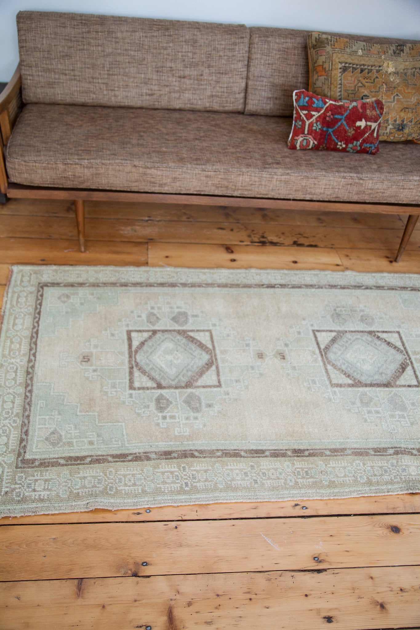 Fringe and pale mint green inner border pattern of the vintage Oushak rug.